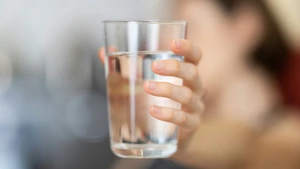 picture of person holding water glass